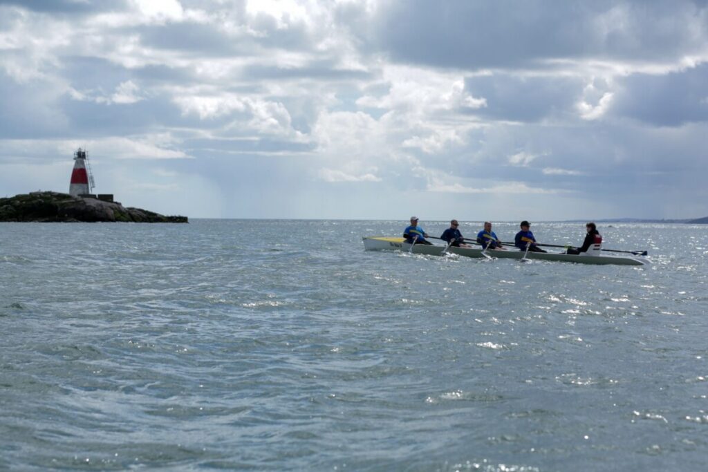 Old Collegians Boat Club men's crew on the outward leg to the Muglins Rock